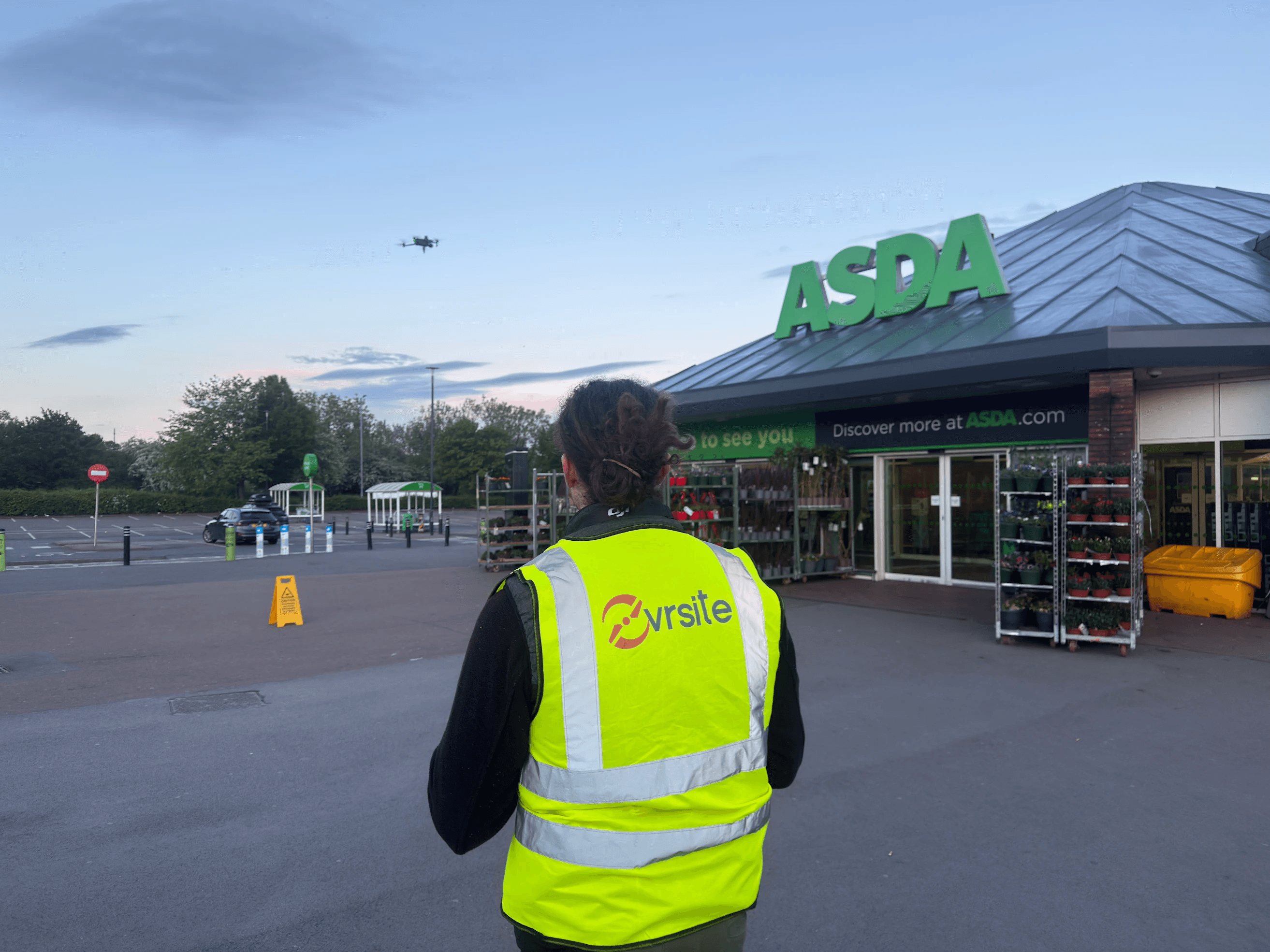 Ovrsite drone on landing pad in Asda car park with store entrance in background