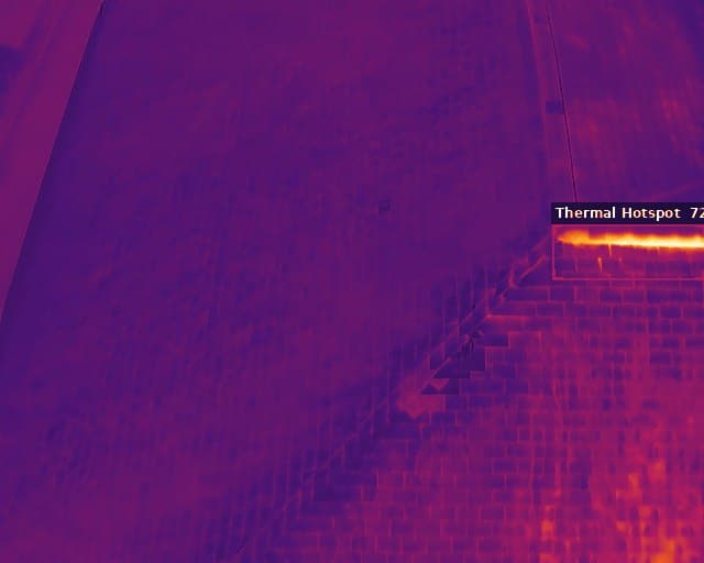 Radiometric thermal image of a roof with a warm anomaly